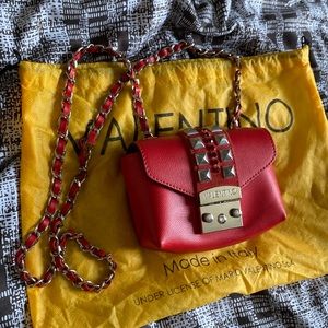 Selling an authentic Valentino small cross body with rhinestone detail .